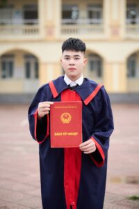 college graduate holding diploma outdoors