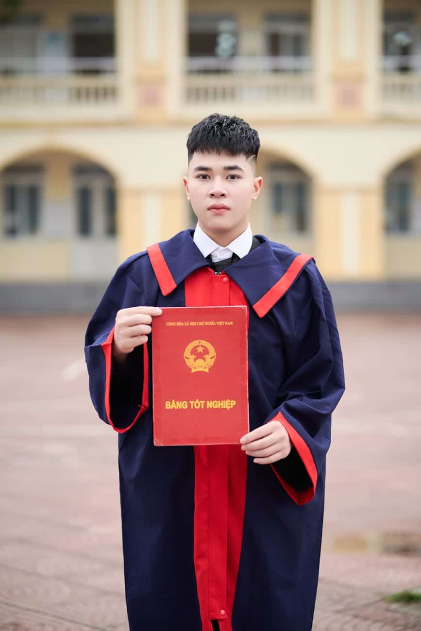 college graduate holding diploma outdoors